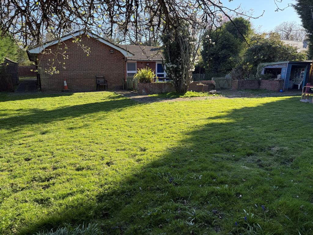 Lot: 87 - FORMER NHS PREMISES WITH POTENTIAL FOR DEVELOPMENT - Lawned rear garden with store
